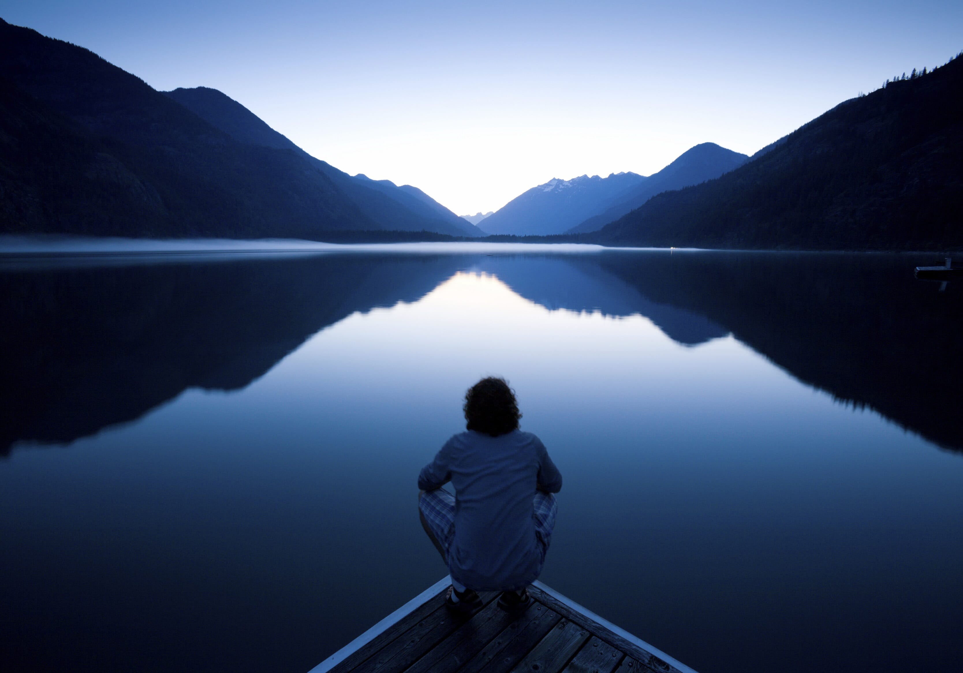 Person looking at lake and mountains